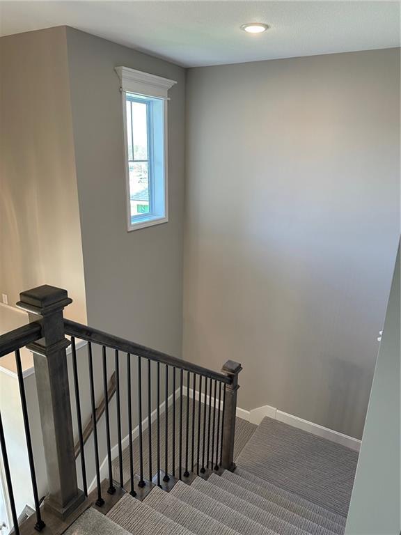 staircase featuring recessed lighting and baseboards