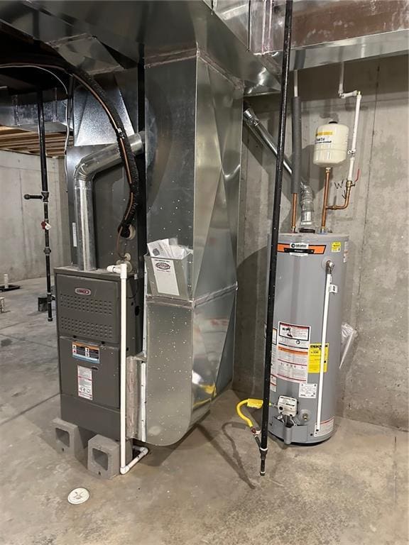 utility room with heating unit and gas water heater