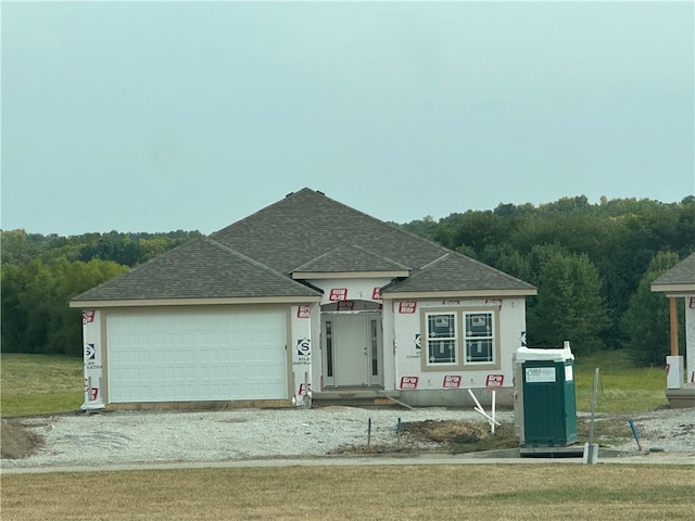 view of front of house with a garage and a front yard