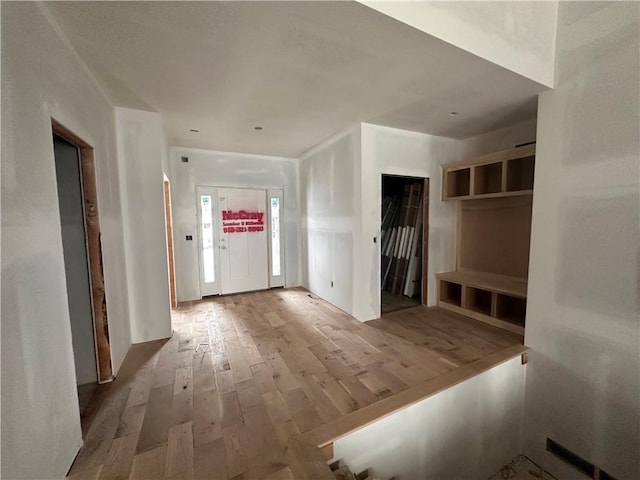 mudroom with wood-type flooring