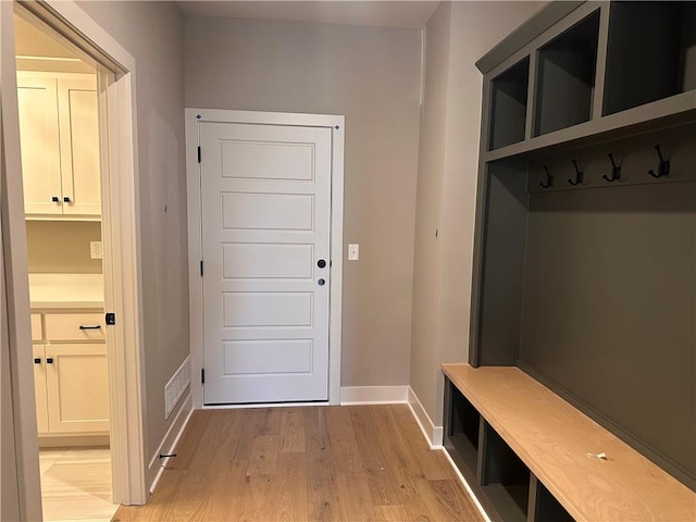 mudroom with light hardwood / wood-style flooring