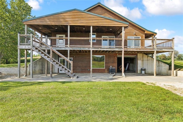 rear view of property featuring a lawn, a patio area, a deck, and central air condition unit