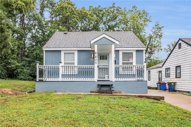 view of front facade with a wooden deck and a front yard