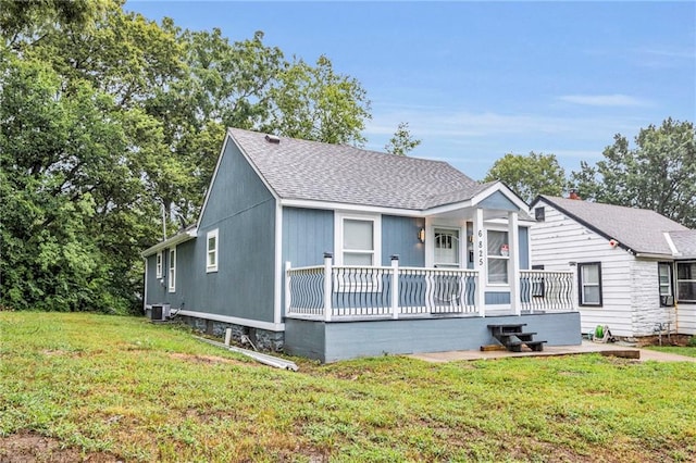6825 Walrond Ave, Kansas City, MO 64132 - bungalow-style house with central AC, a front yard, roof with shingles, and a wooden deck