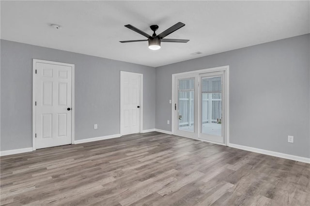 interior space with ceiling fan, access to outside, and hardwood / wood-style flooring