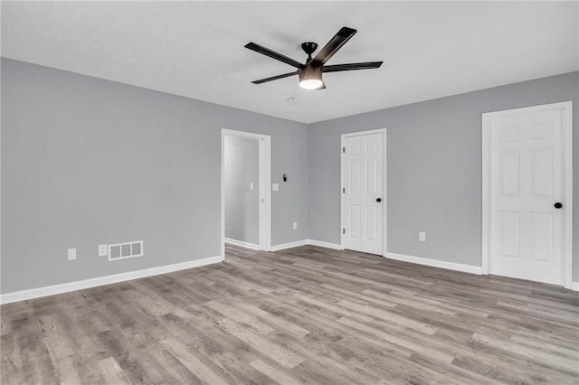 6825 Walrond Ave, Kansas City, MO 64132 - empty room featuring a ceiling fan, baseboards, and wood finished floors