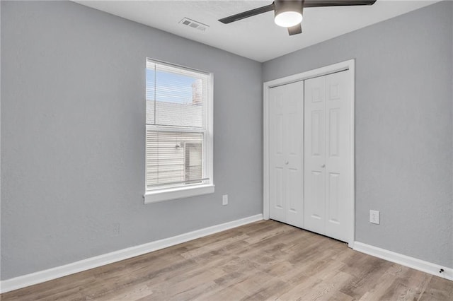 6825 Walrond Ave, Kansas City, MO 64132 - unfurnished bedroom with wood finished floors, a closet, baseboards, and ceiling fan
