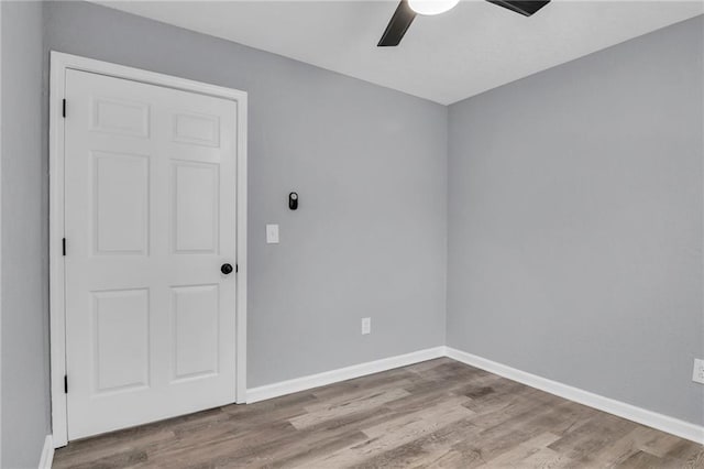 spare room with ceiling fan and hardwood / wood-style floors