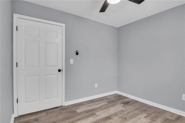 6825 Walrond Ave, Kansas City, MO 64132 - spare room featuring ceiling fan, wood finished floors, and baseboards