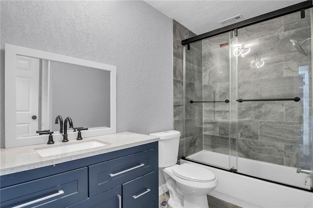 6825 Walrond Ave, Kansas City, MO 64132 - full bath with a textured wall, vanity, a textured ceiling, toilet, and combined bath / shower with glass door