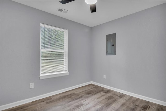 6825 Walrond Ave, Kansas City, MO 64132 - unfurnished room featuring electric panel, a ceiling fan, wood finished floors, and baseboards