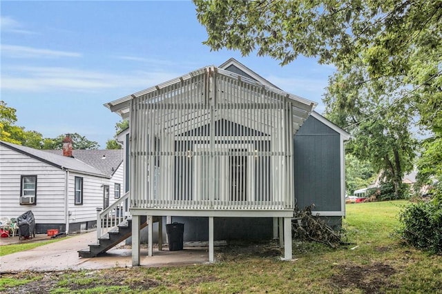 6825 Walrond Ave, Kansas City, MO 64132 - back of property with stairs, a lawn, and cooling unit