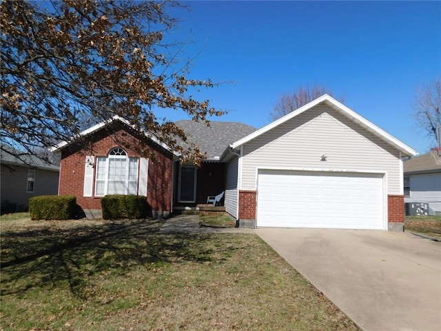 ranch-style house with brick siding, a garage, a front lawn, and driveway