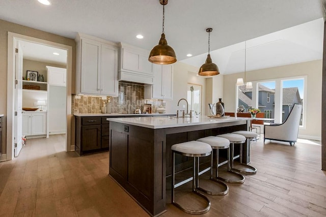 kitchen with white cabinets, pendant lighting, and light countertops