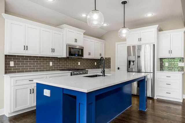 kitchen with backsplash, stainless steel appliances, dark wood-type flooring, and a center island with sink