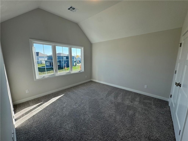 additional living space featuring vaulted ceiling and dark carpet