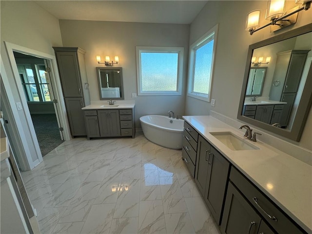 bathroom featuring vanity and a bath