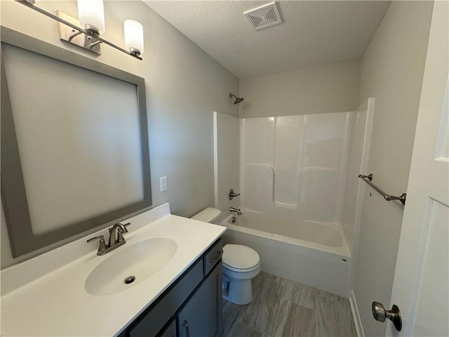 full bathroom with vanity, toilet, a textured ceiling, and tub / shower combination