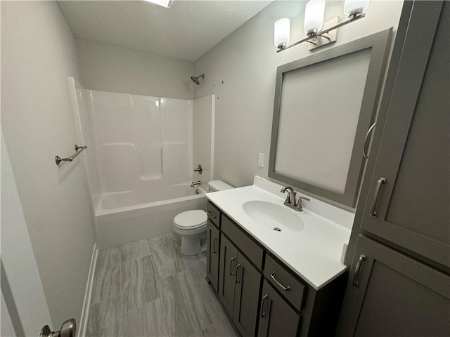 full bathroom featuring toilet, shower / tub combination, vanity, and a textured ceiling