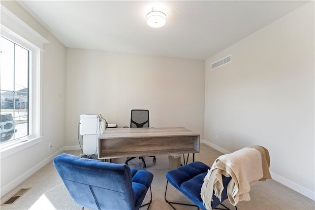 office featuring baseboards, visible vents, and carpet flooring