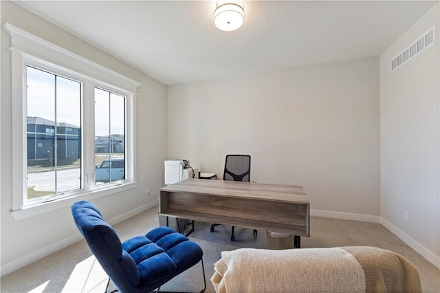 office with light colored carpet, visible vents, and baseboards