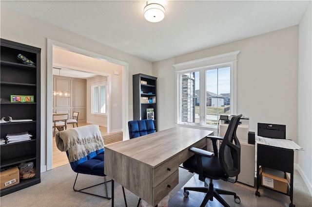 carpeted office space featuring baseboards