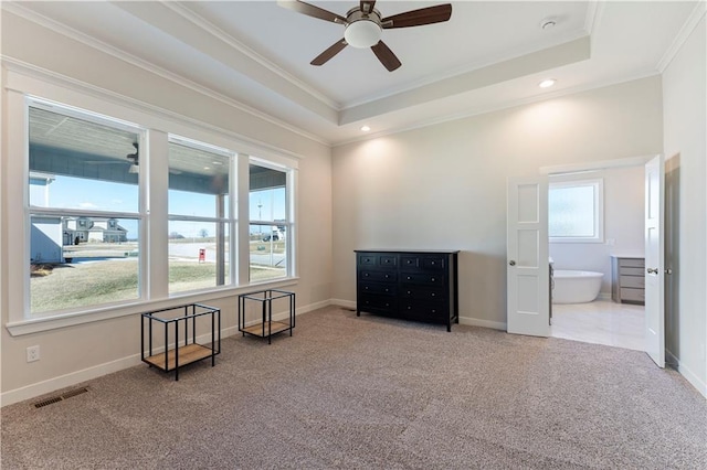 living area featuring ornamental molding, a raised ceiling, carpet flooring, and visible vents