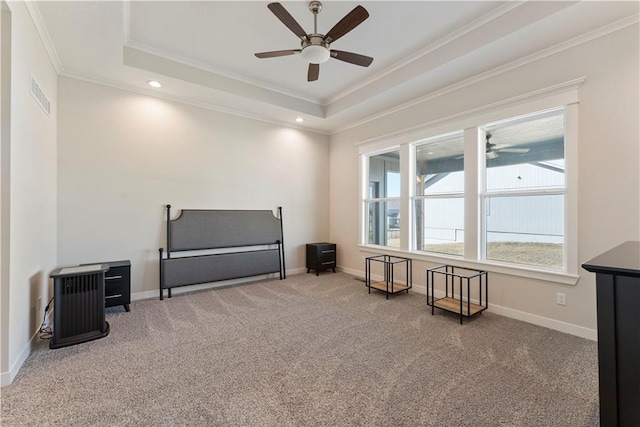 living area with carpet, visible vents, a tray ceiling, and ornamental molding