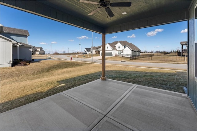 exterior space featuring a ceiling fan and a residential view