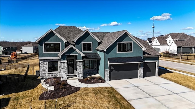 view of front facade with stone siding, a front yard, fence, and stucco siding