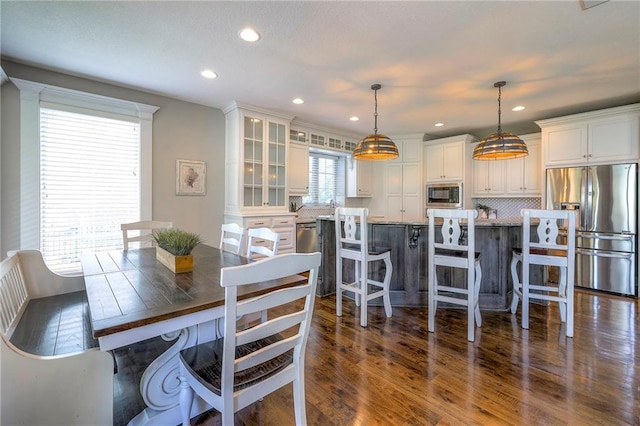 dining room with sink and dark hardwood / wood-style floors