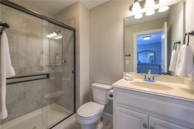 bathroom with vanity, toilet, and walk in shower