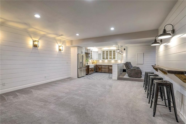 carpeted living room with sink