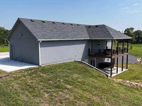 back of property with a patio area and a yard