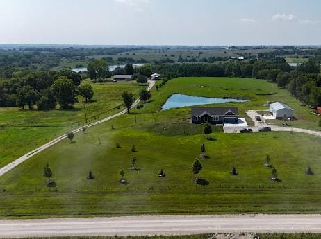 birds eye view of property featuring a rural view and a water view