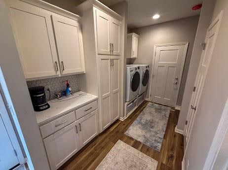 clothes washing area featuring independent washer and dryer and dark hardwood / wood-style flooring