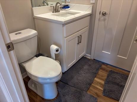 bathroom featuring hardwood / wood-style floors, toilet, and vanity