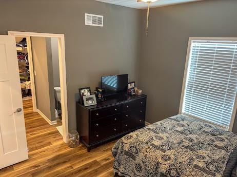 bedroom with a closet and hardwood / wood-style floors