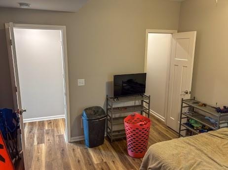 bedroom with hardwood / wood-style flooring