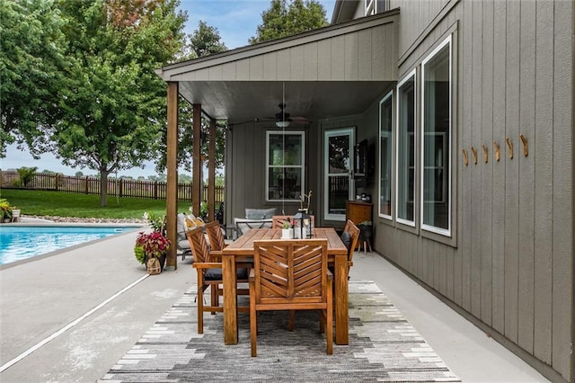 view of patio / terrace with ceiling fan, an outdoor living space, and a fenced in pool