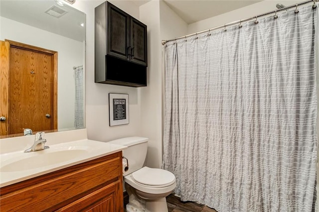 bathroom featuring hardwood / wood-style floors, toilet, and vanity