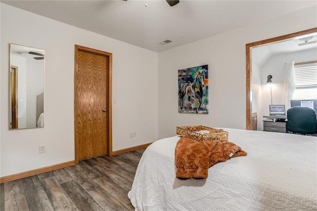 bedroom with ceiling fan, vaulted ceiling, and hardwood / wood-style floors