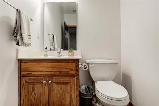 bathroom featuring toilet and vanity