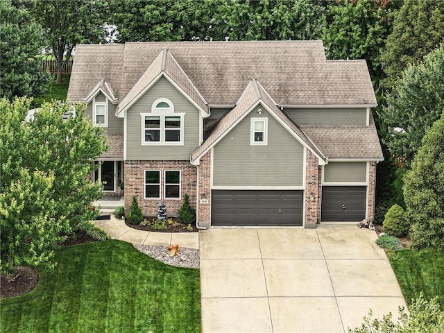 view of front of property with a front yard and a garage