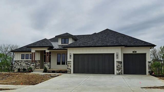 8732 N Lewis Ave, Kansas City, MO 64157 - view of front of house featuring a garage, stone siding, concrete driveway, board and batten siding, and a porch