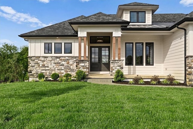 8732 N Lewis Ave, Kansas City, MO 64157 - view of front facade featuring stone siding, a standing seam roof, a front lawn, and metal roof