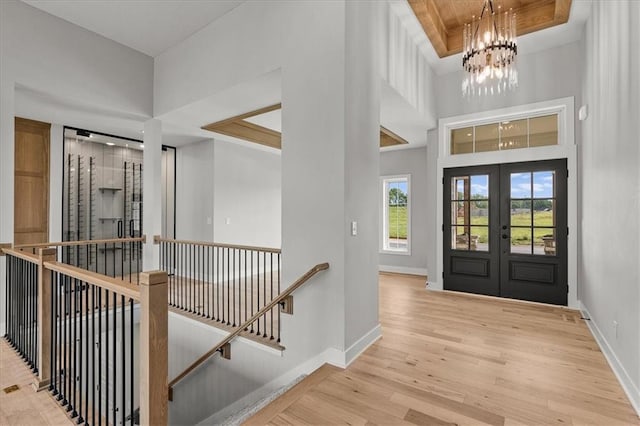 8732 N Lewis Ave, Kansas City, MO 64157 - entrance foyer with a chandelier, french doors, baseboards, wood finished floors, and a high ceiling