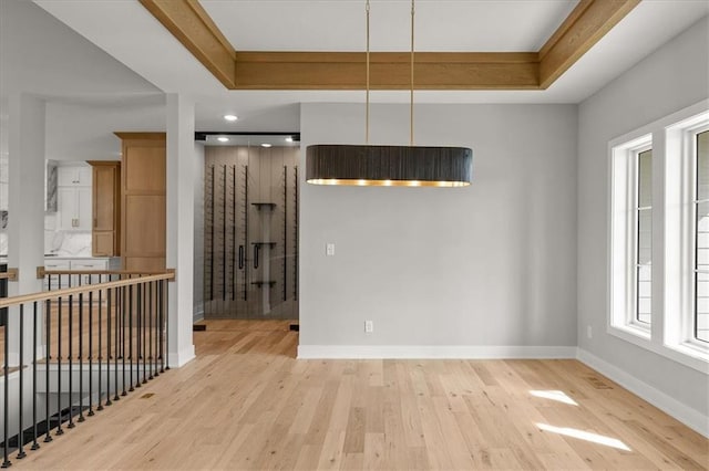 8732 N Lewis Ave, Kansas City, MO 64157 - spare room featuring wood finished floors, baseboards, and a raised ceiling