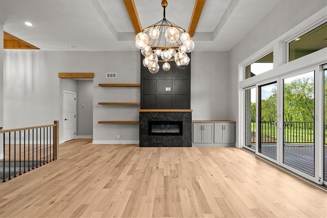 8732 N Lewis Ave, Kansas City, MO 64157 - unfurnished living room with wood finished floors, a chandelier, a high end fireplace, and baseboards