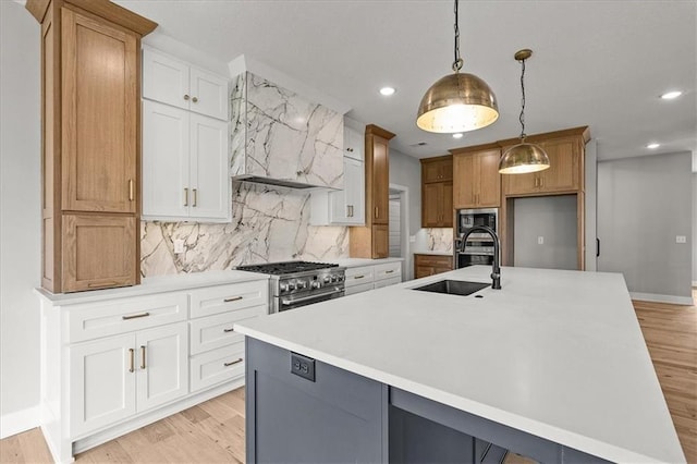 8732 N Lewis Ave, Kansas City, MO 64157 - kitchen with stainless steel stove, a sink, recessed lighting, light countertops, and wall chimney exhaust hood